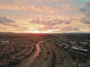 Sunset over a sprawling city with a river running through it