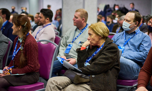 People sit listening to a speaker